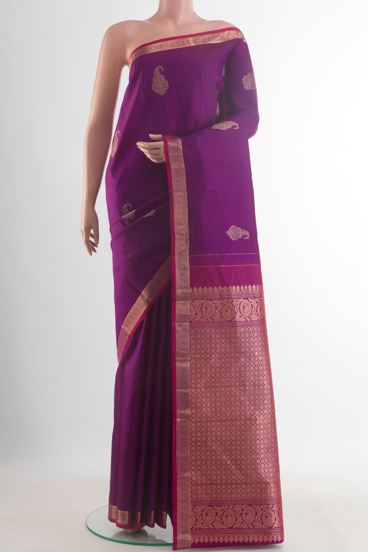 Pure Silk Purple Kanchipuram Saree with Zari Butta on the body and Zari Border.  displayed on a mannequin