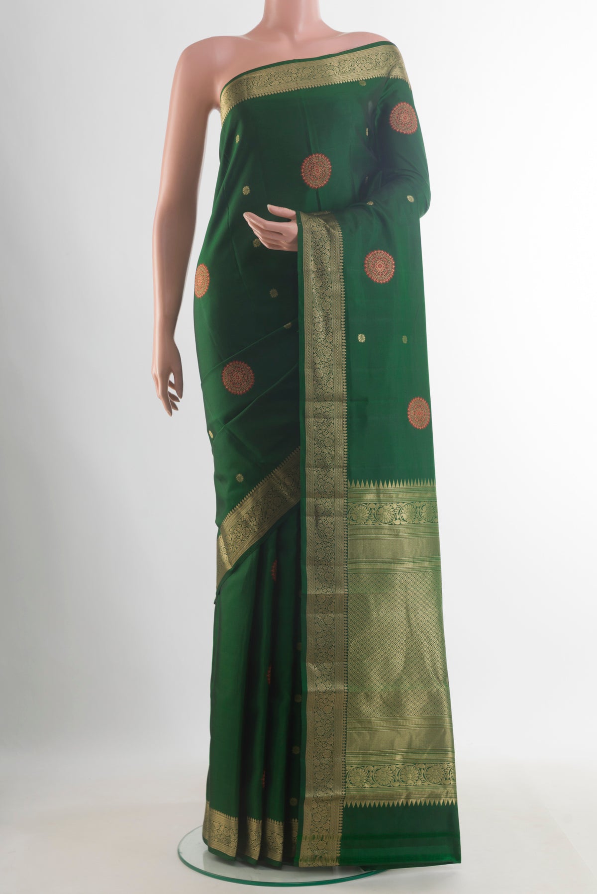 Pure Silk Bottle Green Kanchipuram Saree with Zari Butta on the body and Zari Border.  displayed on a mannequin
