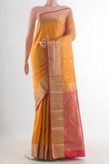Pure Silk Yellow Kanchipuram Saree with Zari Butta on the body and Zari Border.  displayed on a mannequin