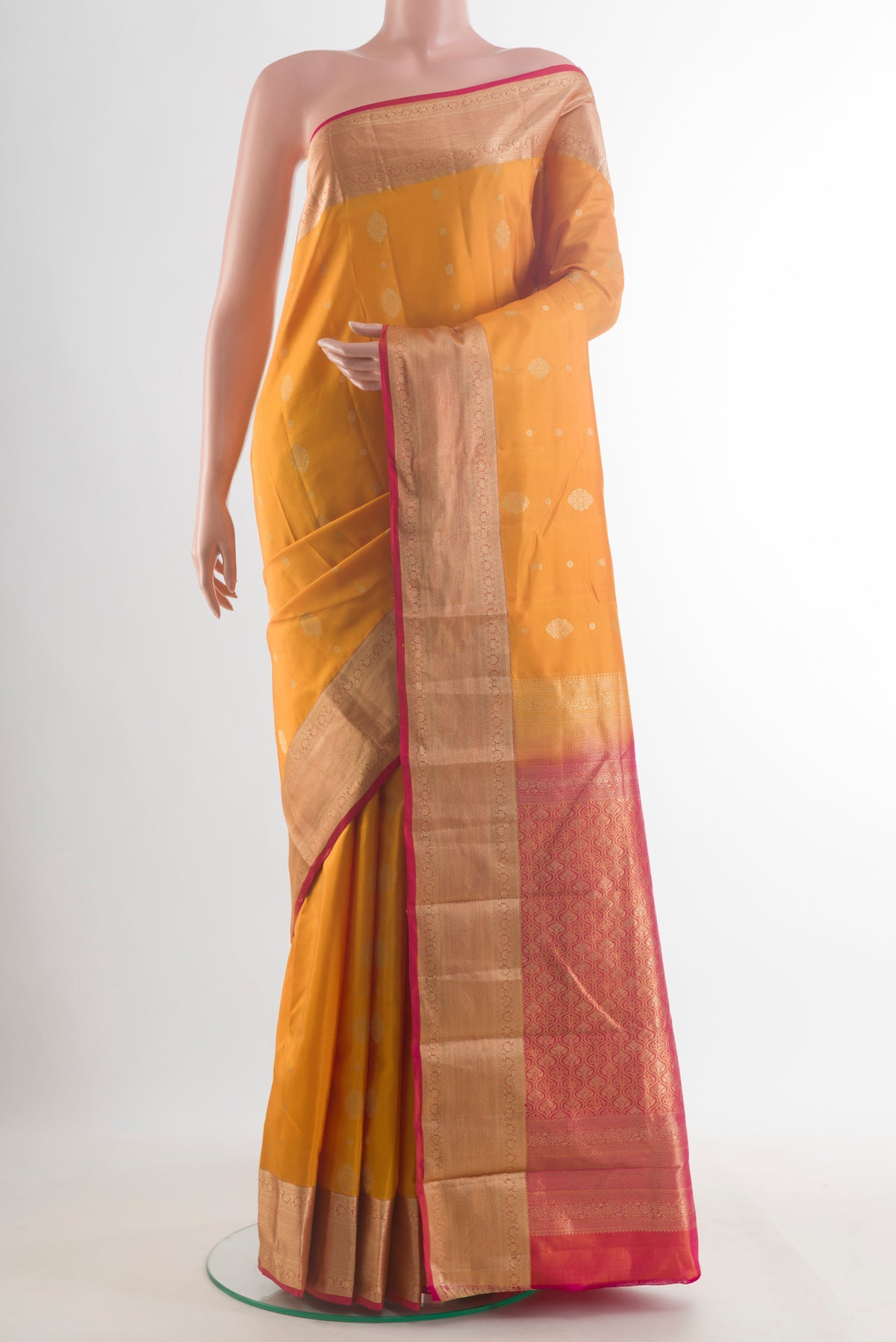 Pure Silk Yellow Kanchipuram Saree with Zari Butta on the body and Zari Border.  displayed on a mannequin