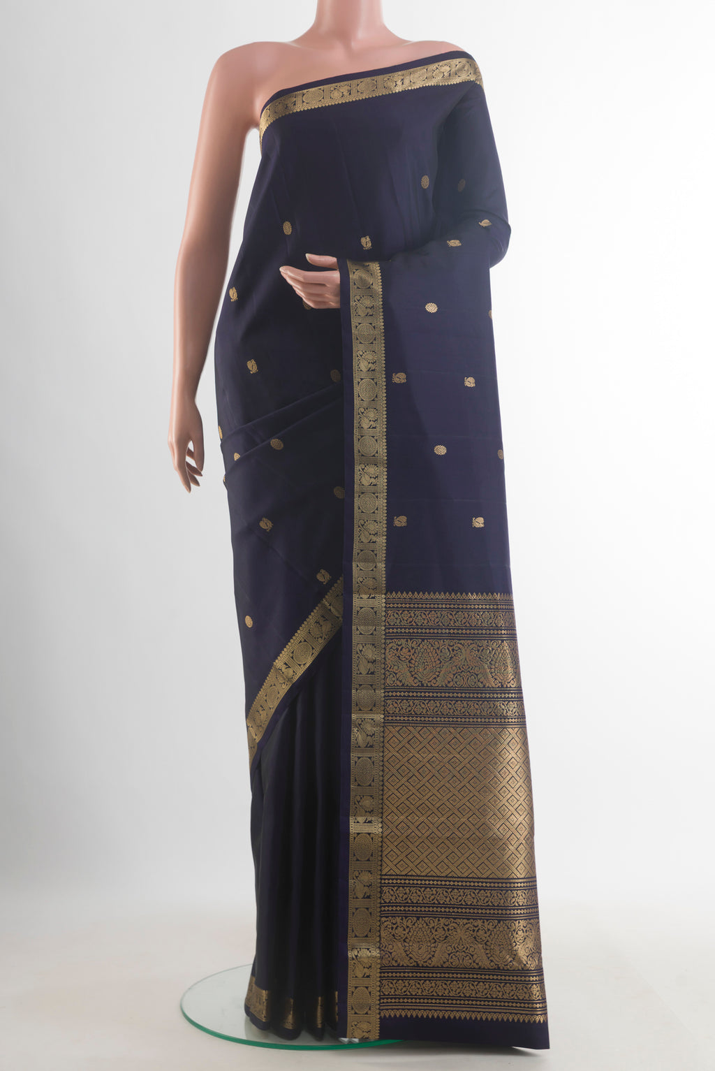 Pure Silk Navy Blue Kanchipuram Saree with Zari Butta on the body and Zari Border.  displayed on a mannequin