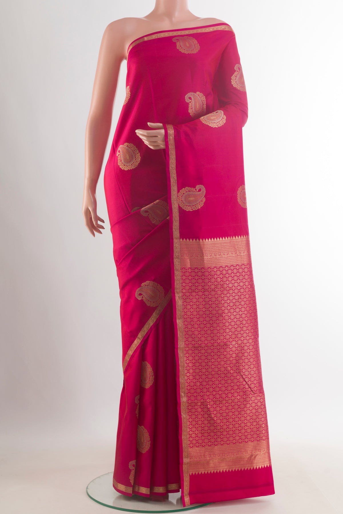 Pure Silk Pink Kanchipuram Saree with Zari Butta on the body and Zari Border.  displayed on a mannequin