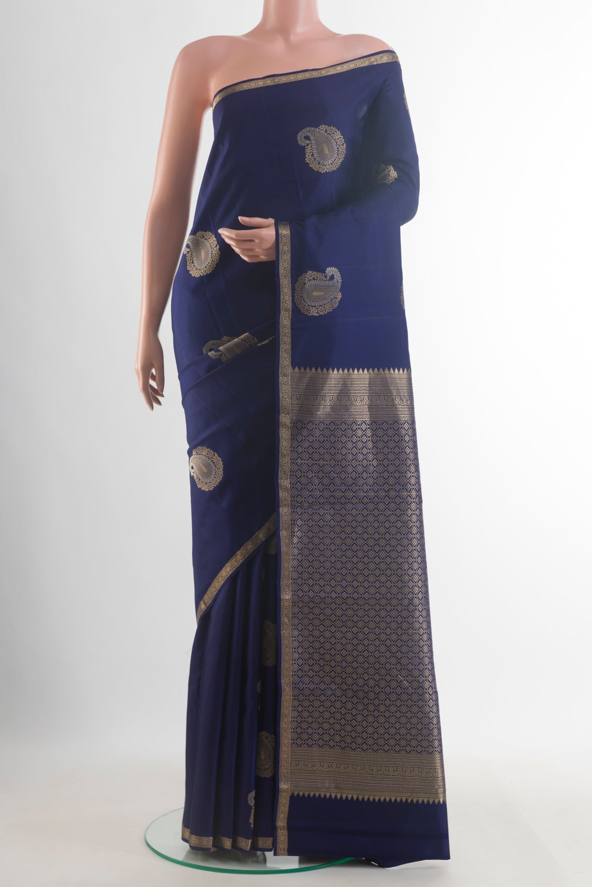 Pure Silk Navy Blue Kanchipuram Saree with Zari Butta on the body and Zari Border.  displayed on a mannequin
