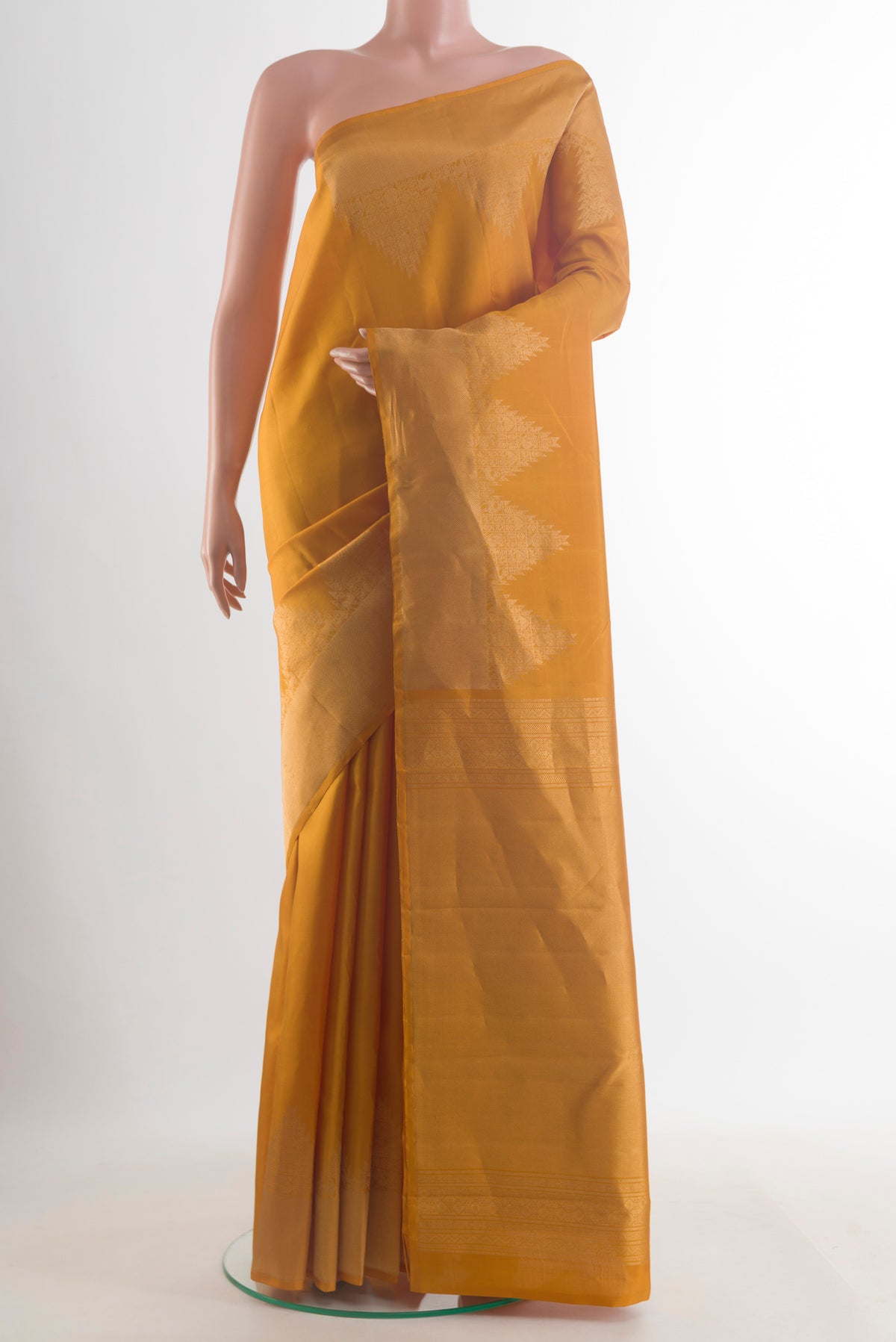 Pure Silk Mustard Kanchipuram Saree with Plain Body and Zari Border.  displayed on a mannequin