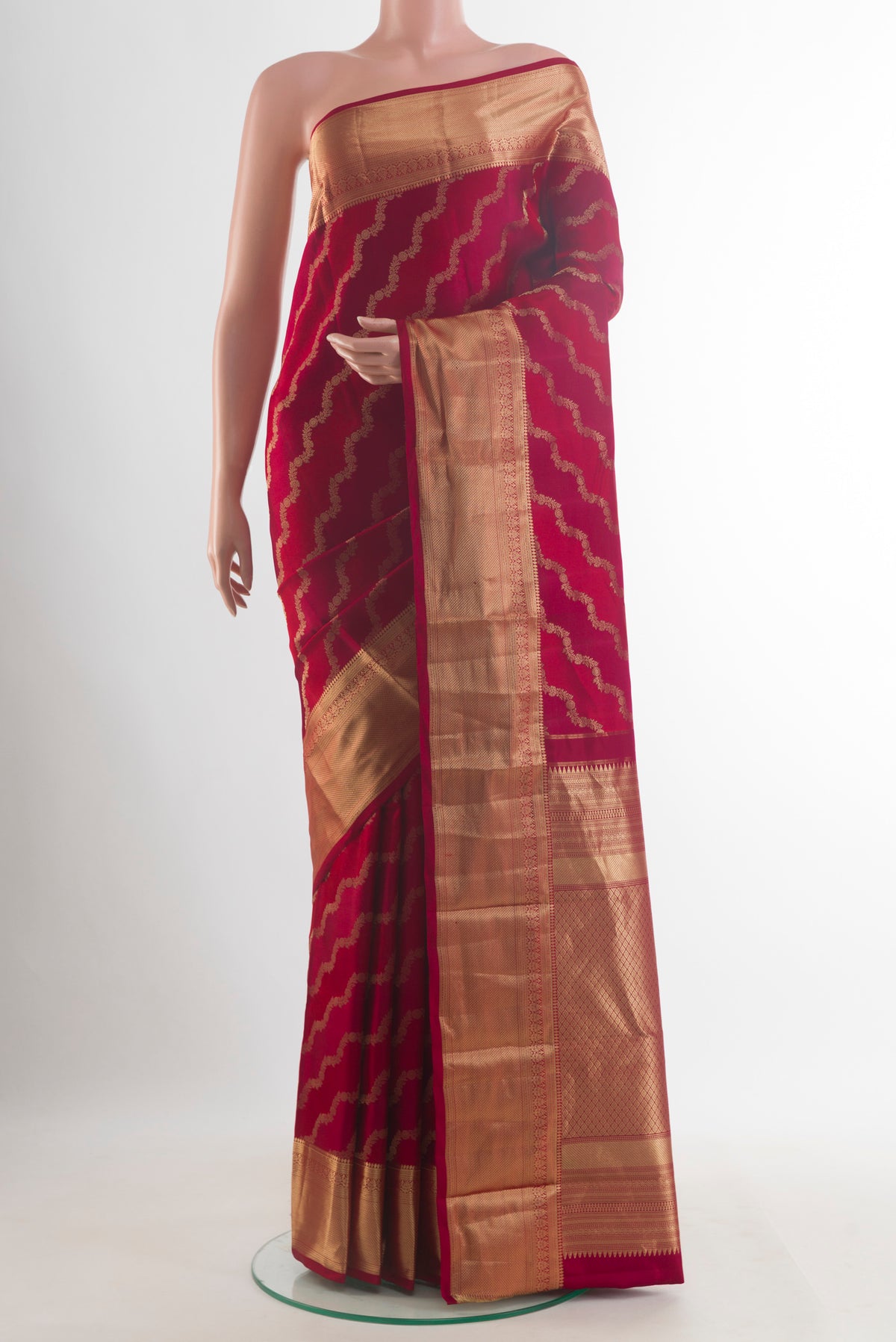 Pure Silk Red Kanjivaram Saree with Zari Brocade on the body and Zari Border.  displayed on a mannequin