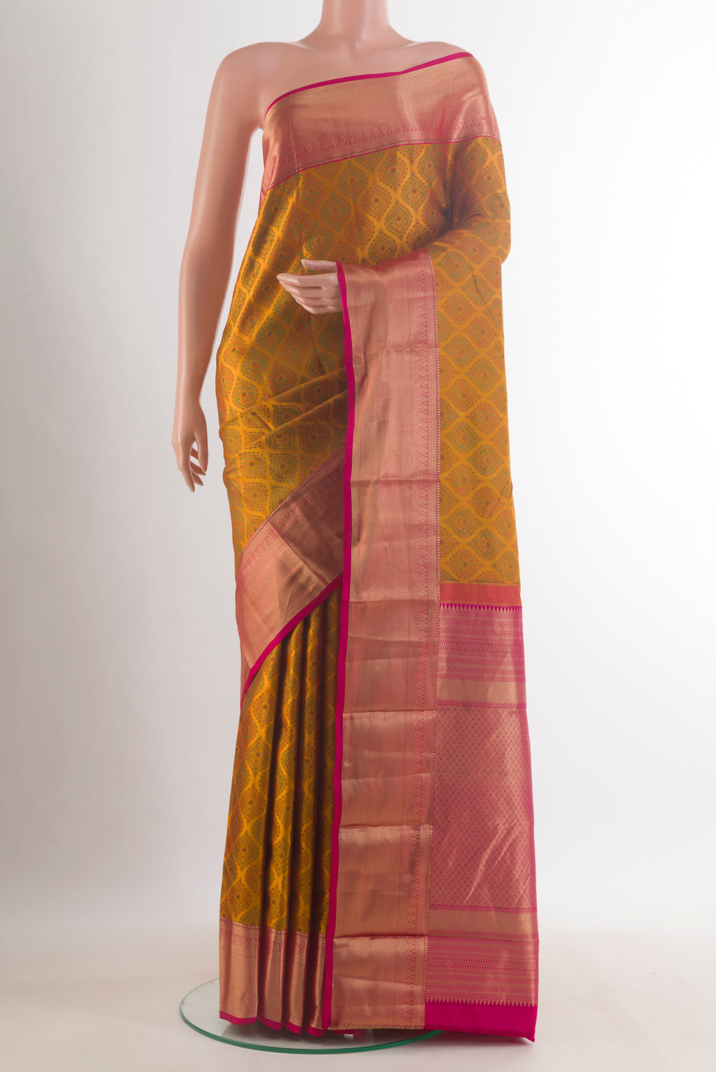 Pure Silk Mustard Kanchipuram Saree with Jacquard design on the body and Zari Border.  displayed on a mannequin