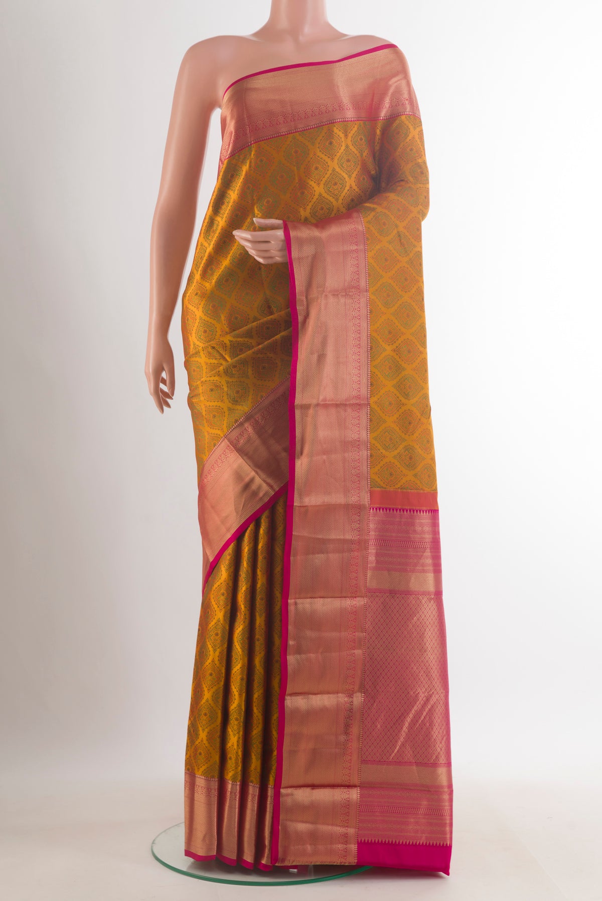 Pure Silk Mustard Kanchipuram Saree with Jacquard design on the body and Zari Border.  displayed on a mannequin