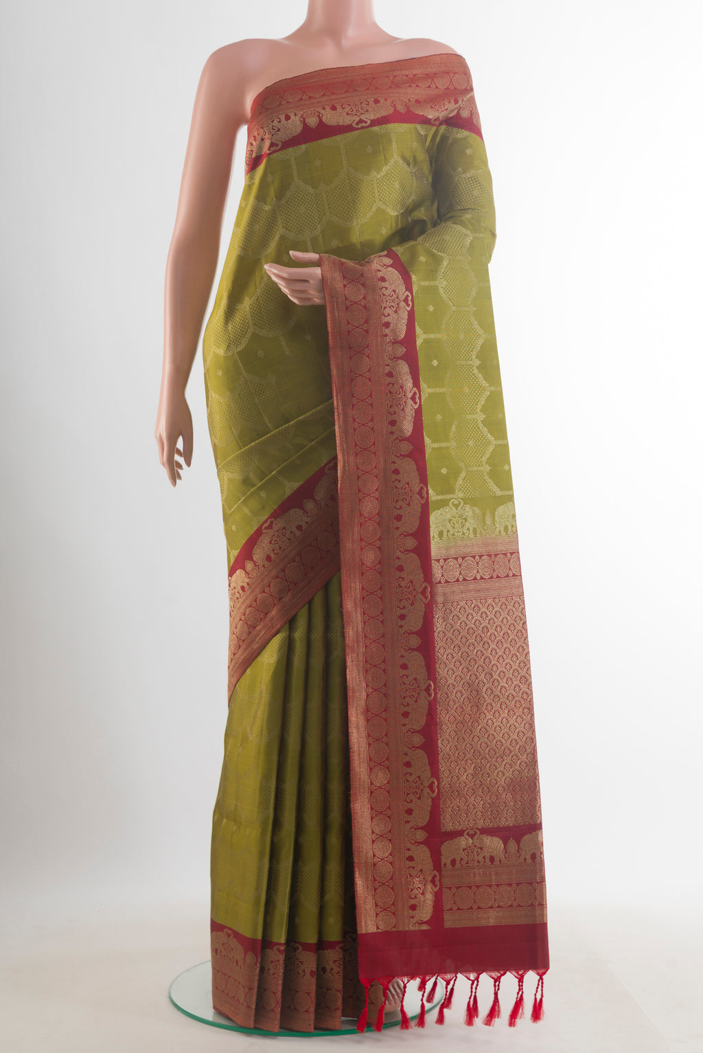 Pure Silk Mehandi Green Soft Saree with Zari Brocade on the body and Zari Border.  displayed on a mannequin