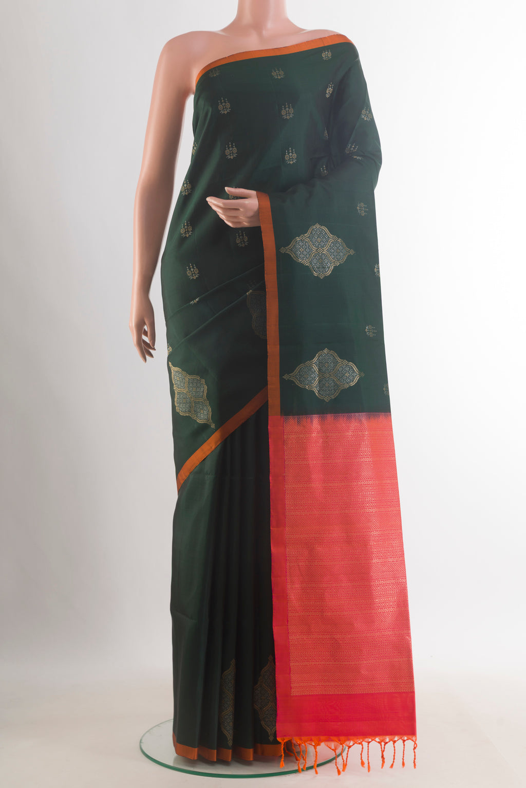 Pure Silk Bottle Green Soft Saree with Zari Butta on the body and Plain Border.  displayed on a mannequin