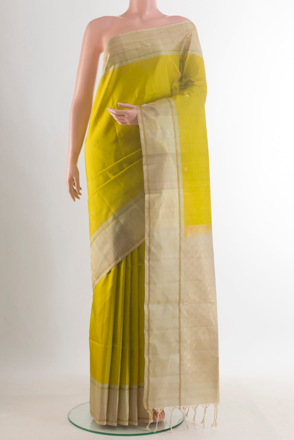 Pure Silk Light Green Soft Saree with Zari Butta on the body and Zari Border.  displayed on a mannequin