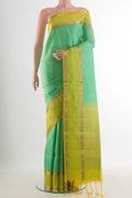 Pure Silk Mint Green Soft Saree with Stripes on the body and Zari Border.  displayed on a mannequin