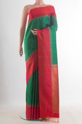 Pure Silk Green Soft Saree with Zari Butta on the body and Zari Border.  displayed on a mannequin
