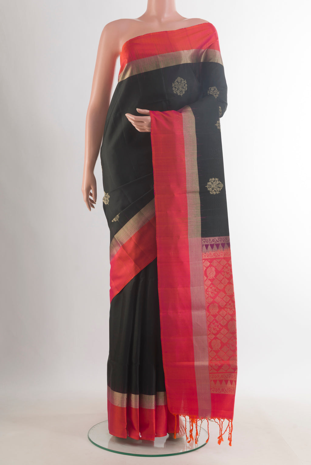 Pure Silk Black Soft Saree with Zari Butta on the body and Zari Border.  displayed on a mannequin