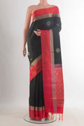 Pure Silk Black Soft Saree with Zari Butta on the body and Zari Border.  displayed on a mannequin
