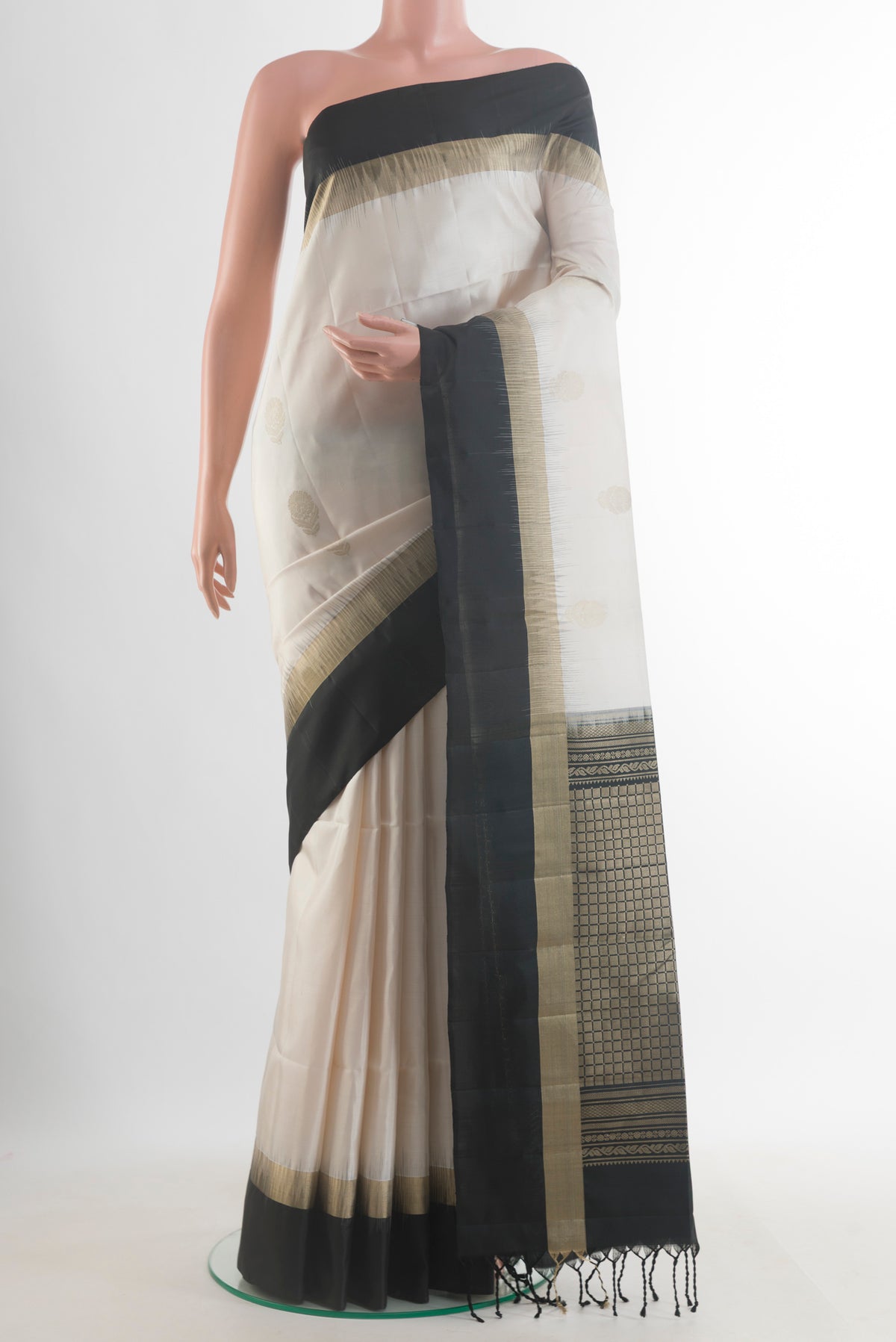 Pure Silk Off White Soft Saree with Zari Butta on the body and Zari Border.  displayed on a mannequin