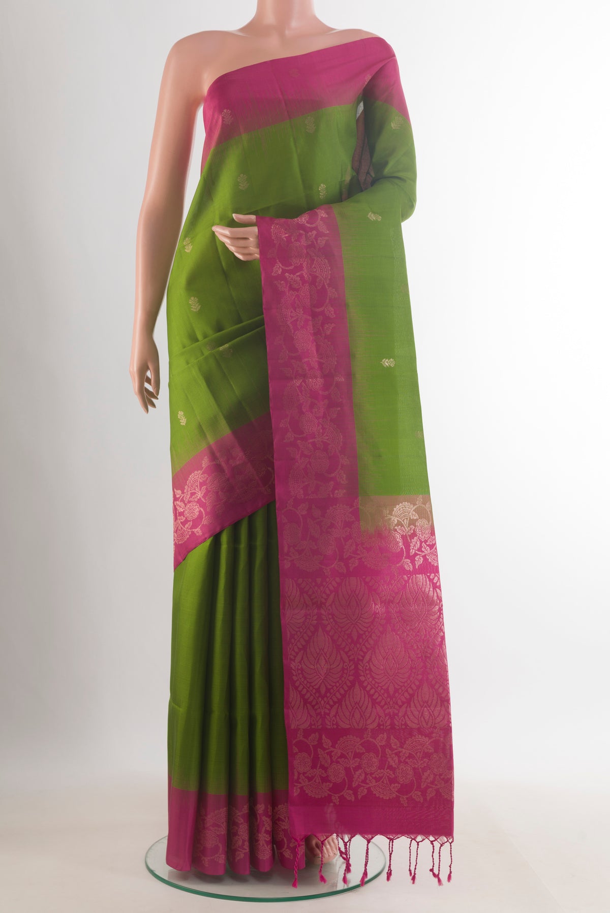 Pure Silk Green Soft Saree with Zari Butta on the body and Zari Border.  displayed on a mannequin