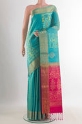 Pure Silk Turquoise Soft Saree with Ikat design on the body and Zari Border.  displayed on a mannequin