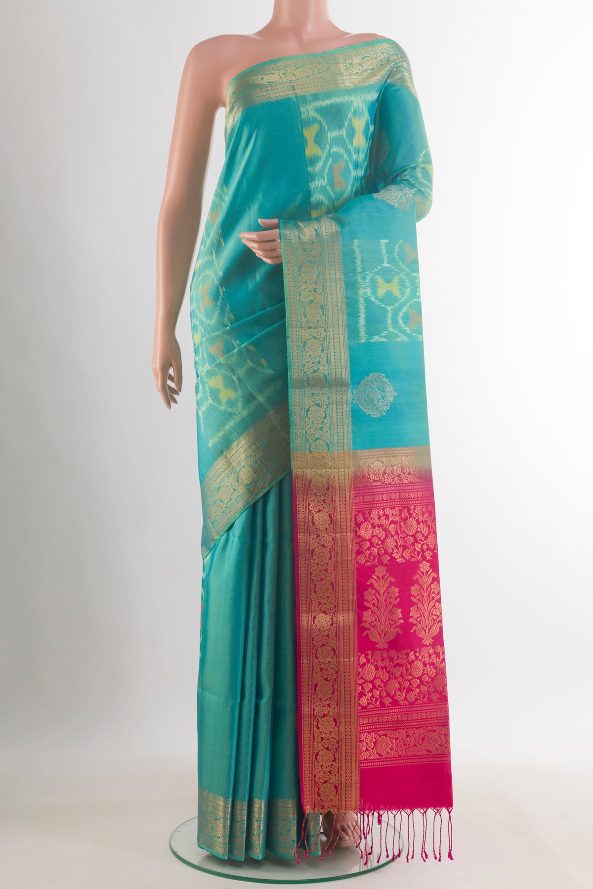 Pure Silk Turquoise Soft Saree with Ikat design on the body and Zari Border.  displayed on a mannequin