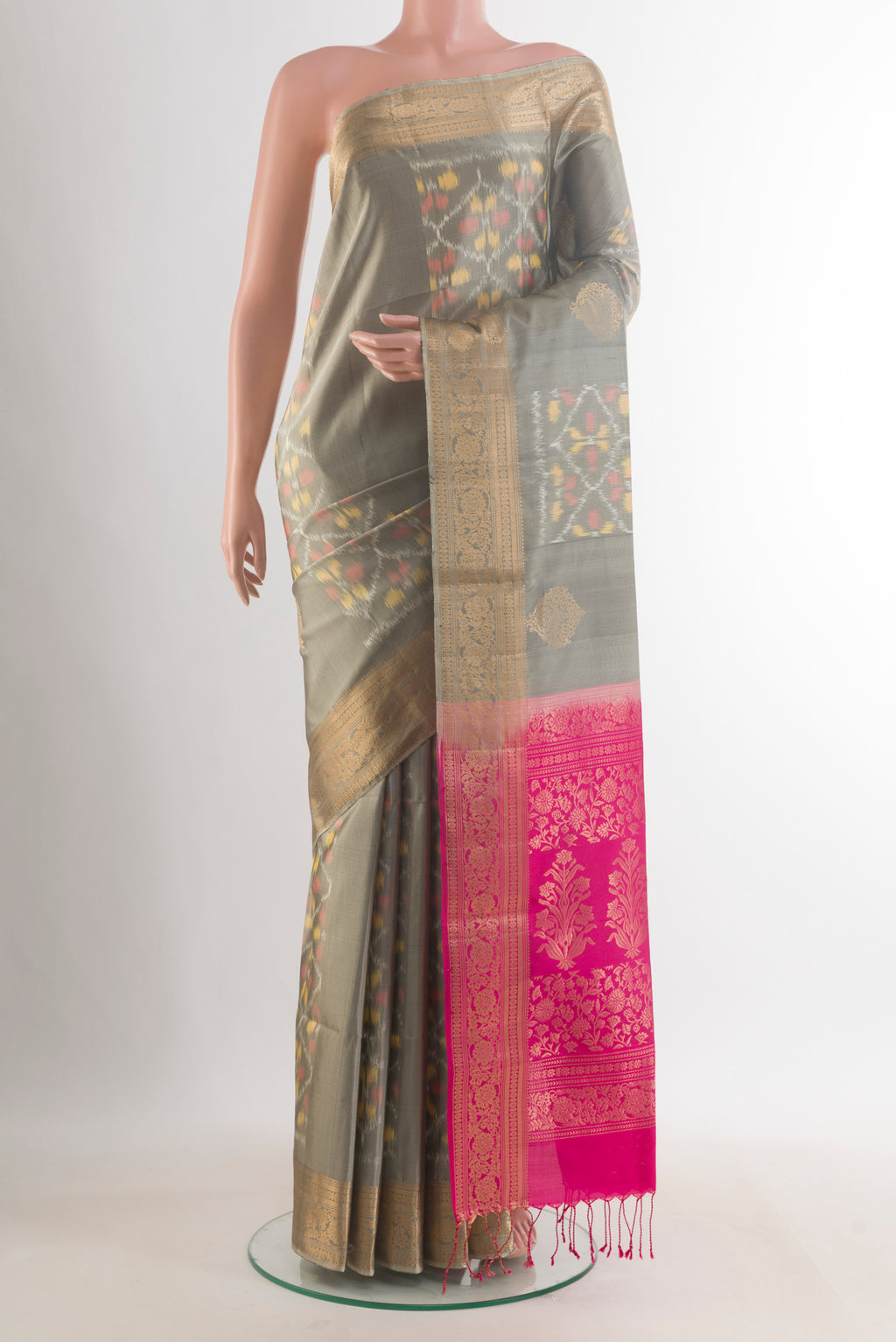 Pure Silk Grey Soft Saree with Ikat design on the body and Zari Border.  displayed on a mannequin