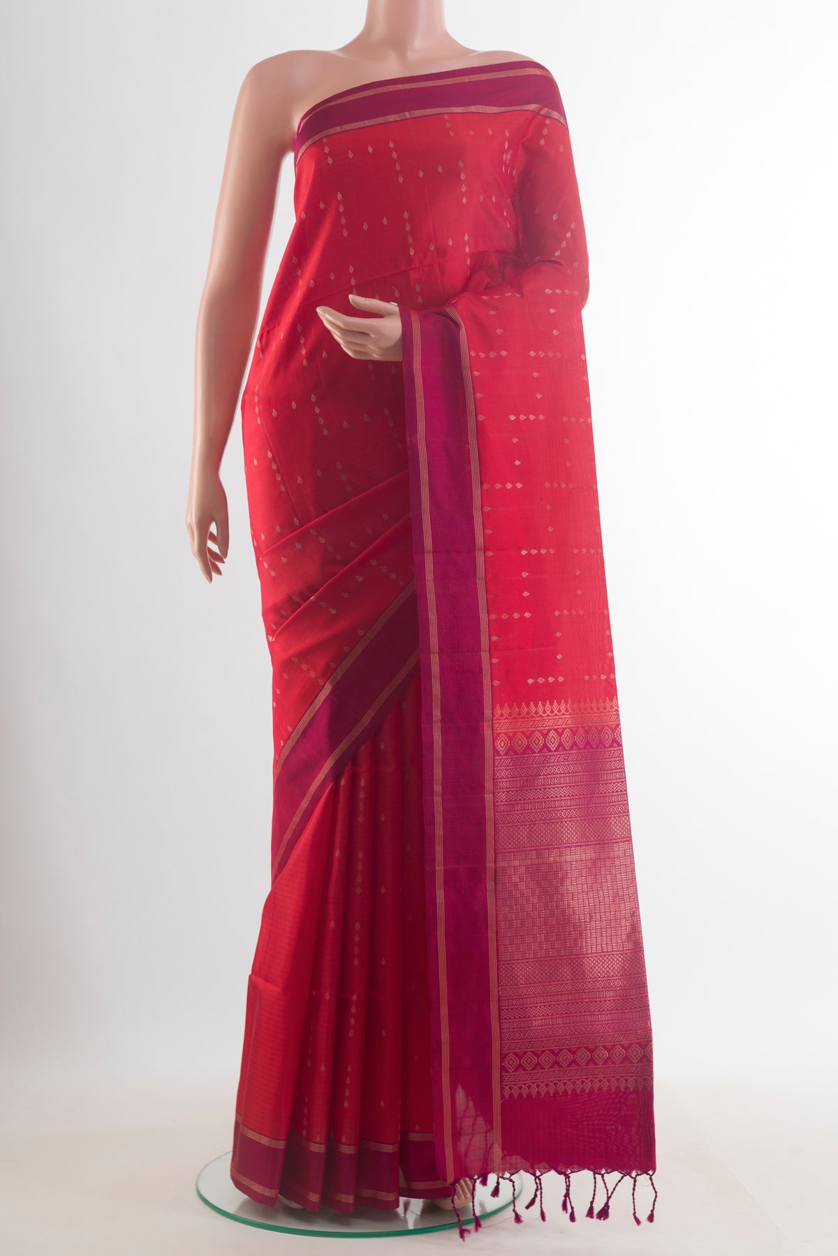 Pure Silk Red Soft Saree with Zari Butta on the body and Zari Border.  displayed on a mannequin