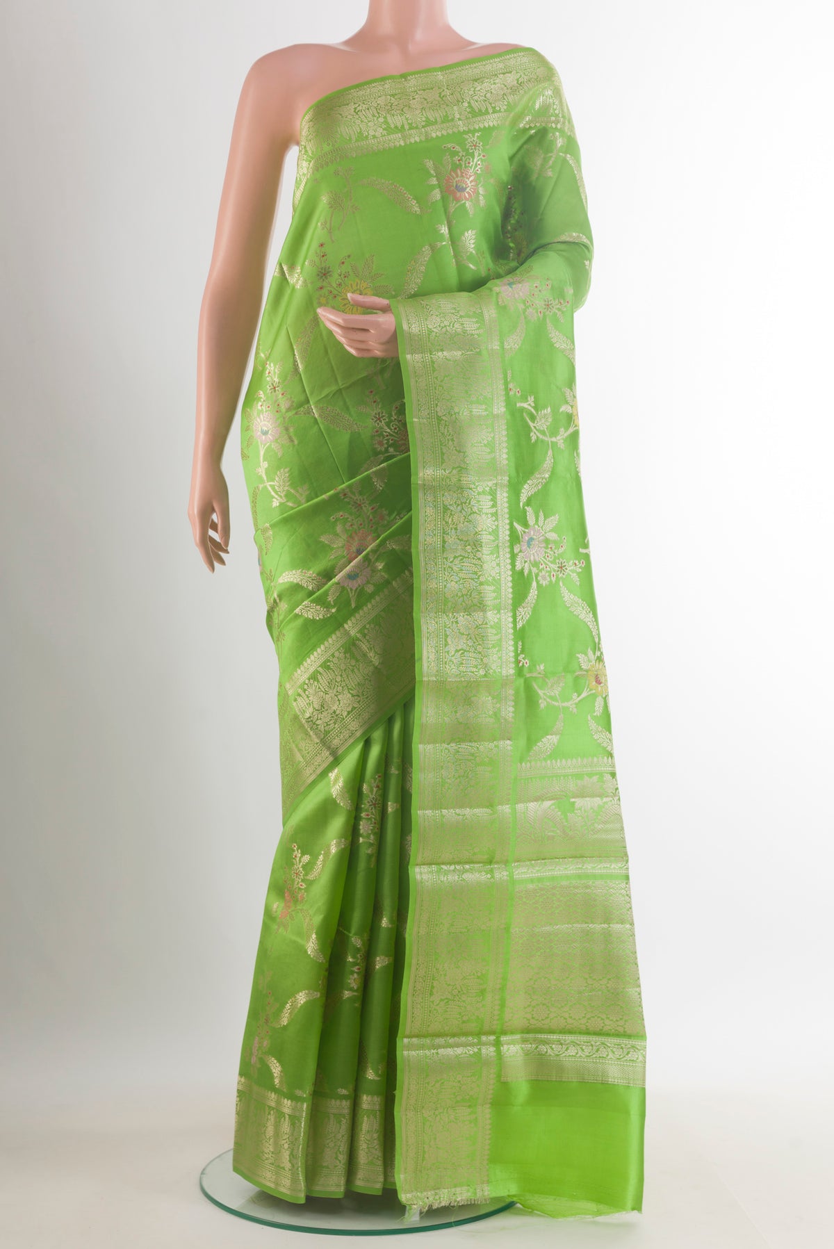 Parrot Green Tussar Saree with Zari Brocade on the body and Zari Border.  displayed on a mannequin