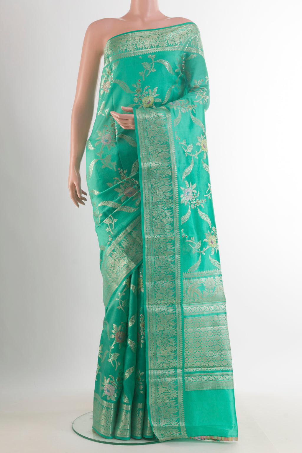 Sea Green Tussar Saree with Zari Brocade on the body and Zari Border.  displayed on a mannequin