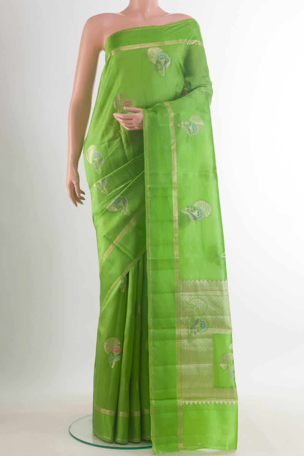 Green Tussar Saree with Zari Butta on the body and Zari Border.  displayed on a mannequin