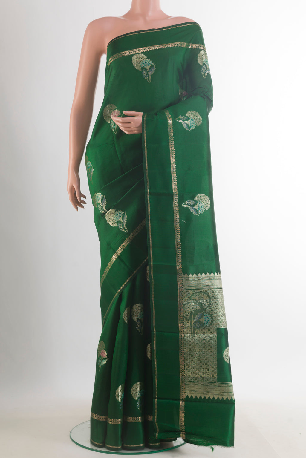 Bottle Green Tussar Saree with Zari Butta on the body and Zari Border.  displayed on a mannequin