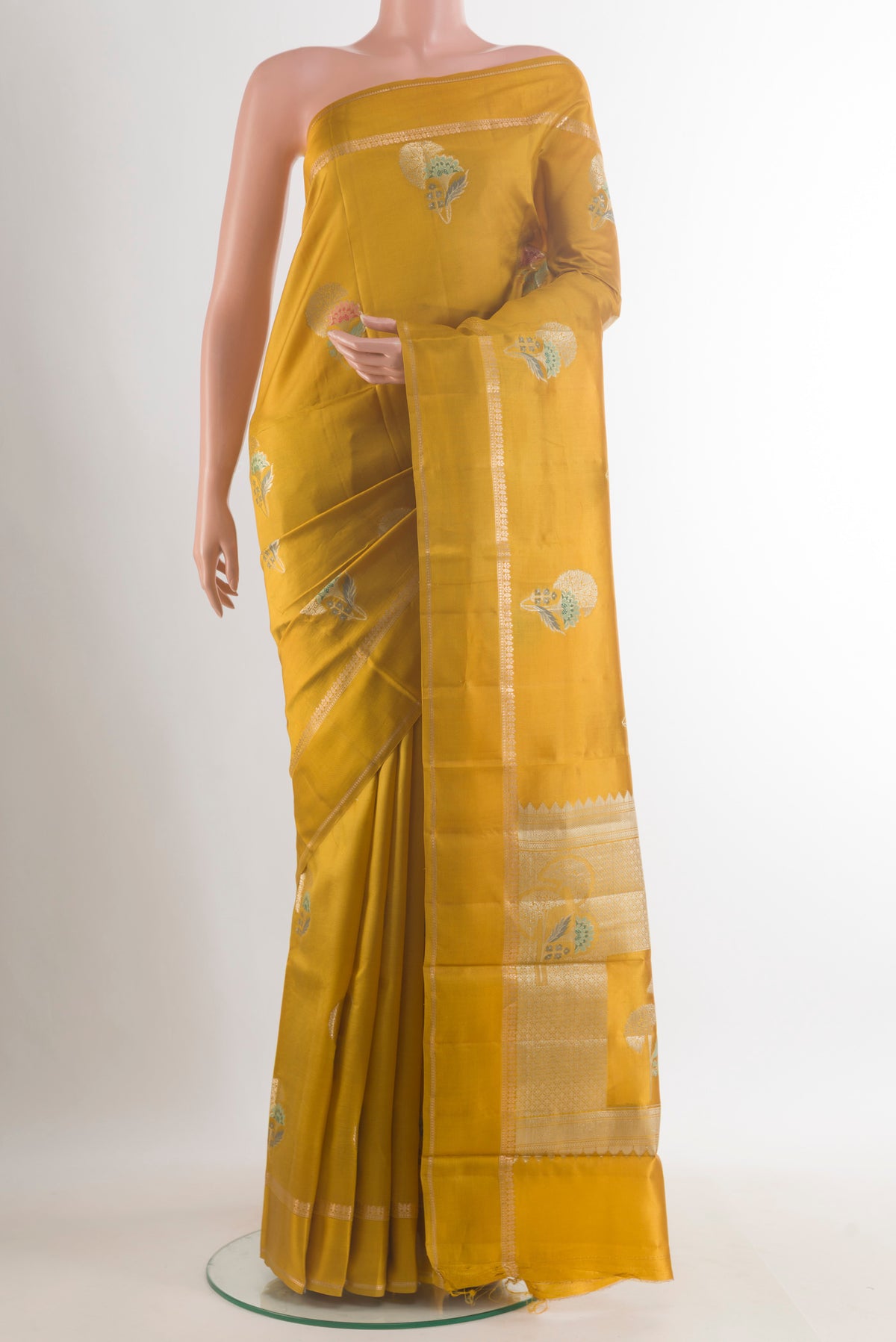 Mustard Tussar Saree with Zari Butta on the body and Zari Border.  displayed on a mannequin