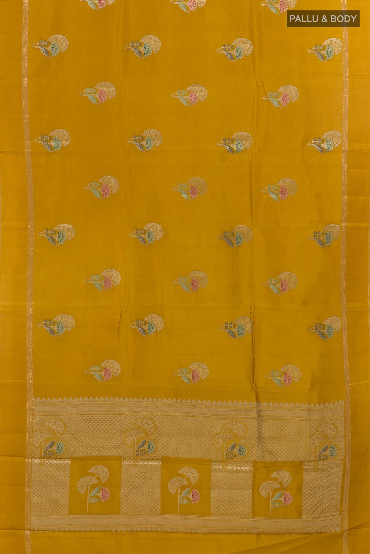 Flat view of Mustard Tussar Saree with Zari Butta on the body and Zari Border. 