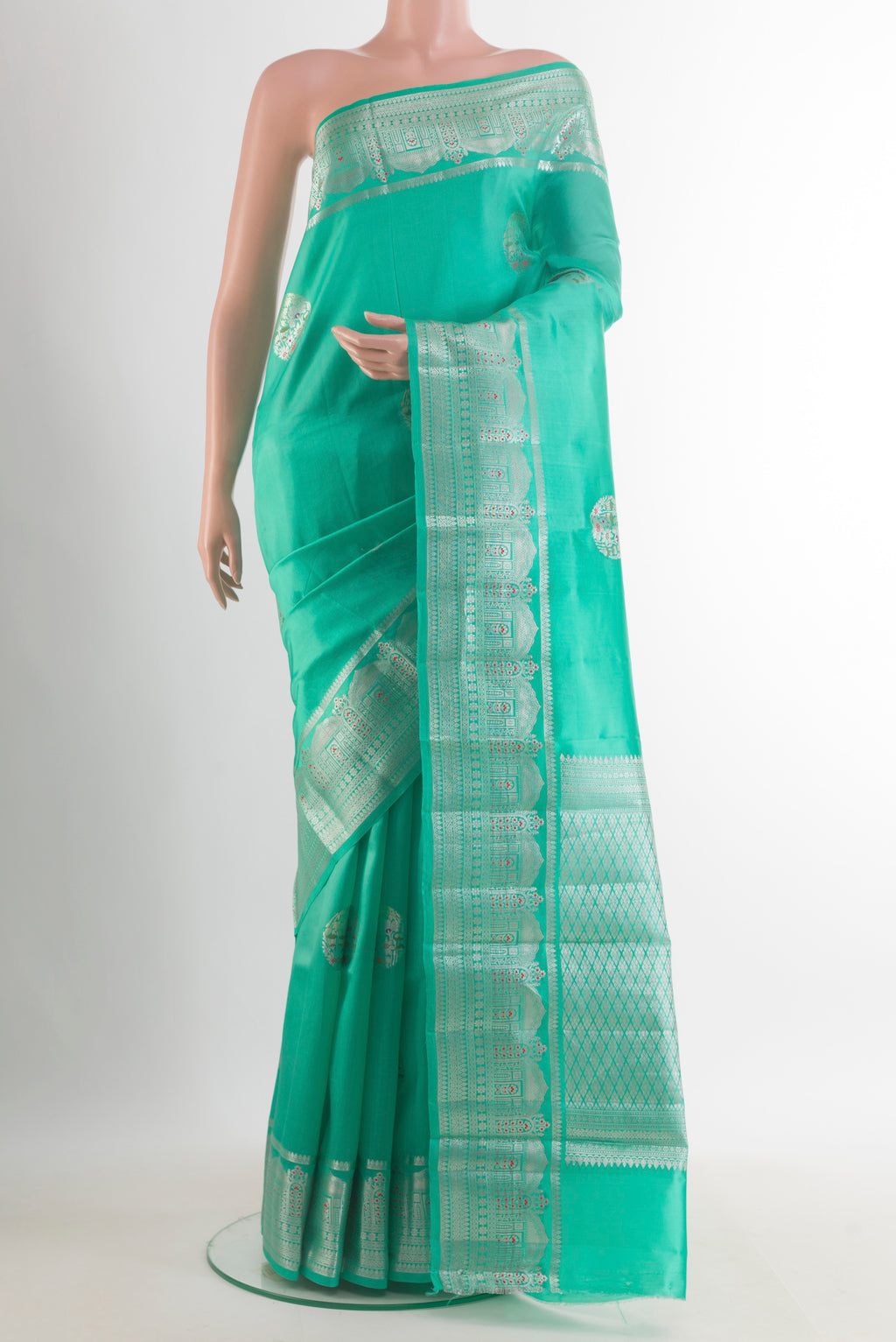 Sea Green Tussar Saree with Zari Butta on the body and Zari Border.  displayed on a mannequin
