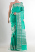 Sea Green Tussar Saree with Zari Butta on the body and Zari Border.  displayed on a mannequin