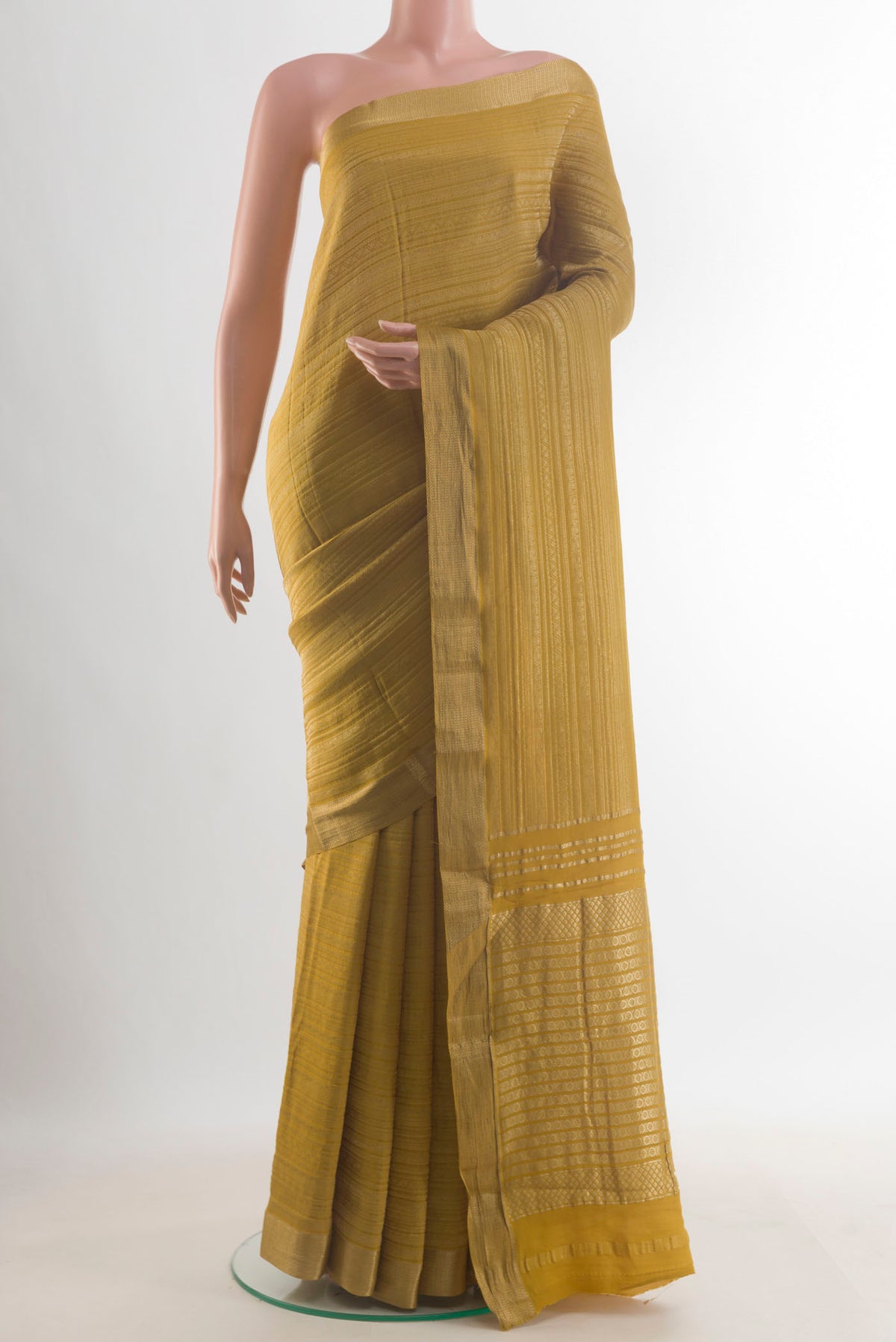 Mustard Mysore Crepe Saree with Zari Brocade on the body and Zari Border.  displayed on a mannequin