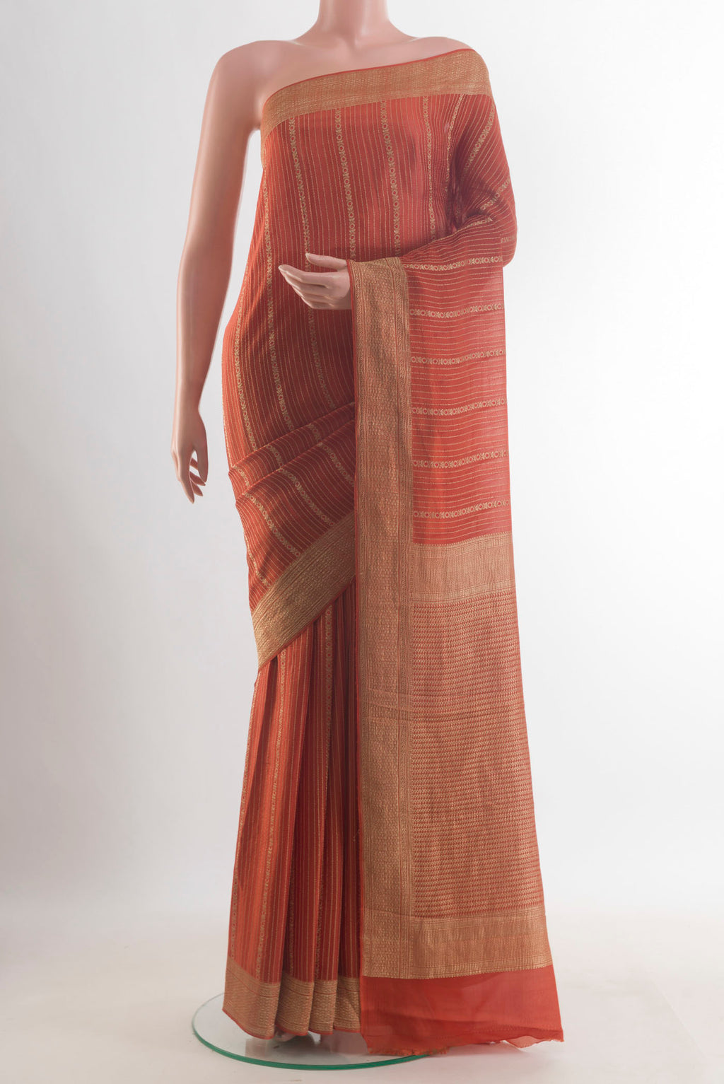 Orange Mysore Crepe Saree with Stripes on the body and Zari Border.  displayed on a mannequin