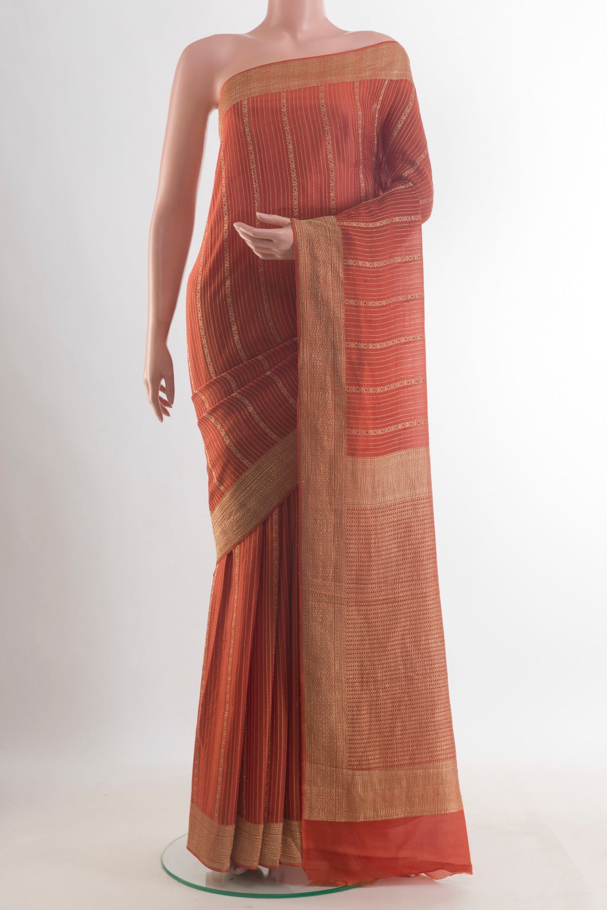 Orange Mysore Crepe Saree with Stripes on the body and Zari Border.  displayed on a mannequin