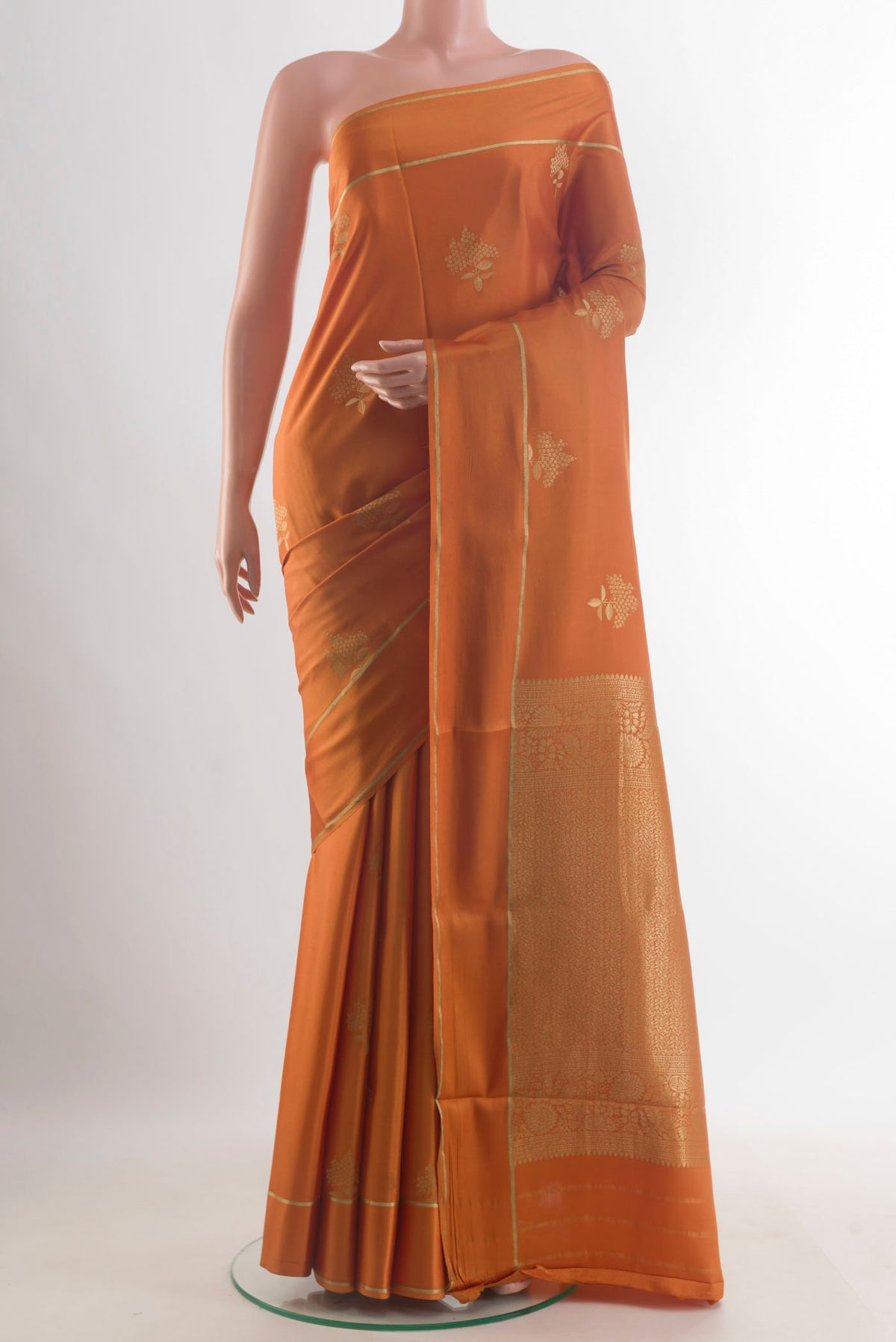 Orange Mysore Crepe Saree with Zari Butta on the body and Zari Border.  displayed on a mannequin