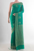 Sea Green Mysore Crepe Saree with Zari Butta on the body and Zari Border.  displayed on a mannequin