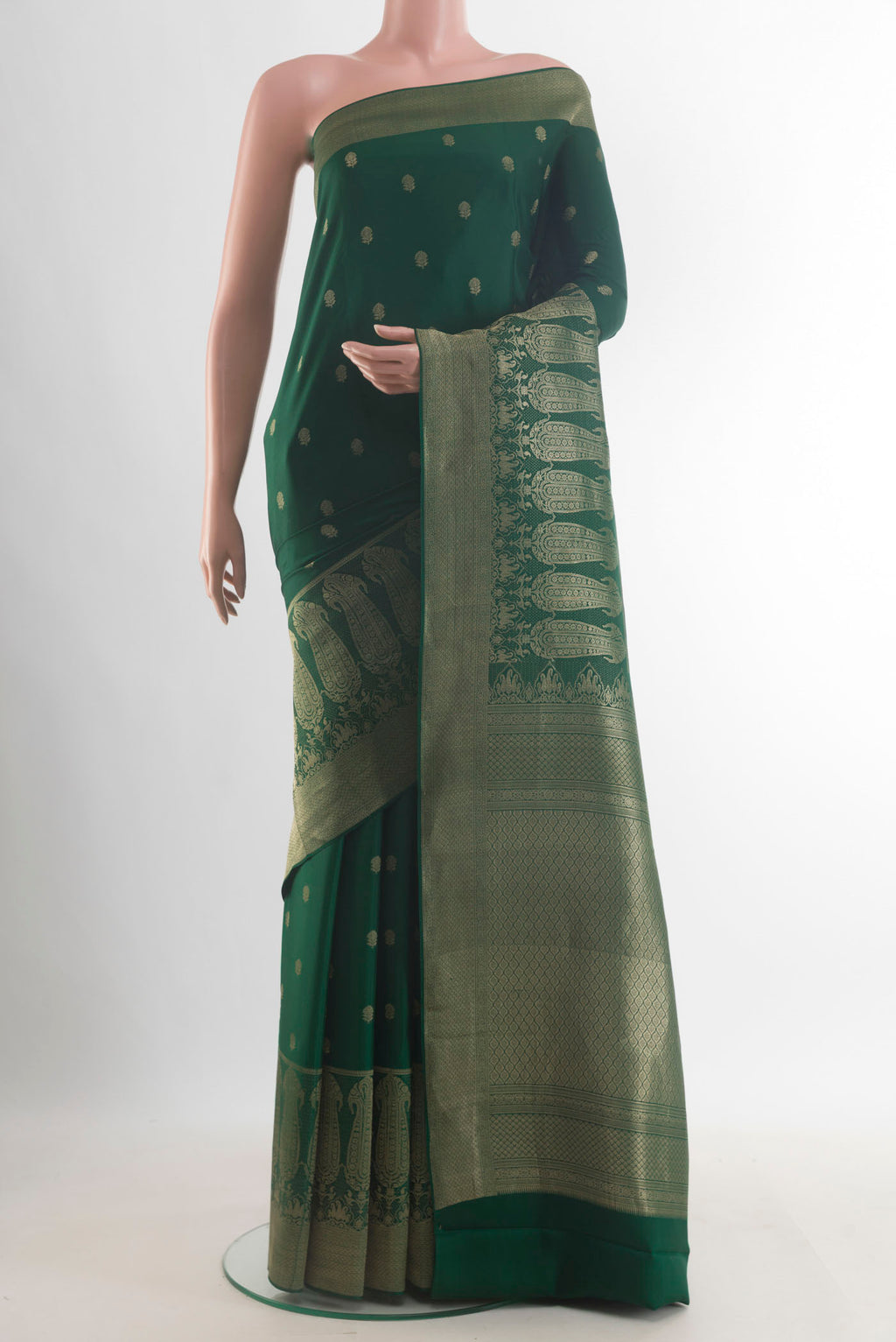 Bottle Green Mysore Crepe Saree with Zari Butta on the body and Zari Border.  displayed on a mannequin
