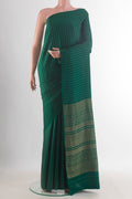 Green Mysore Crepe Saree with Zari Butta on the body and Without Border.  displayed on a mannequin