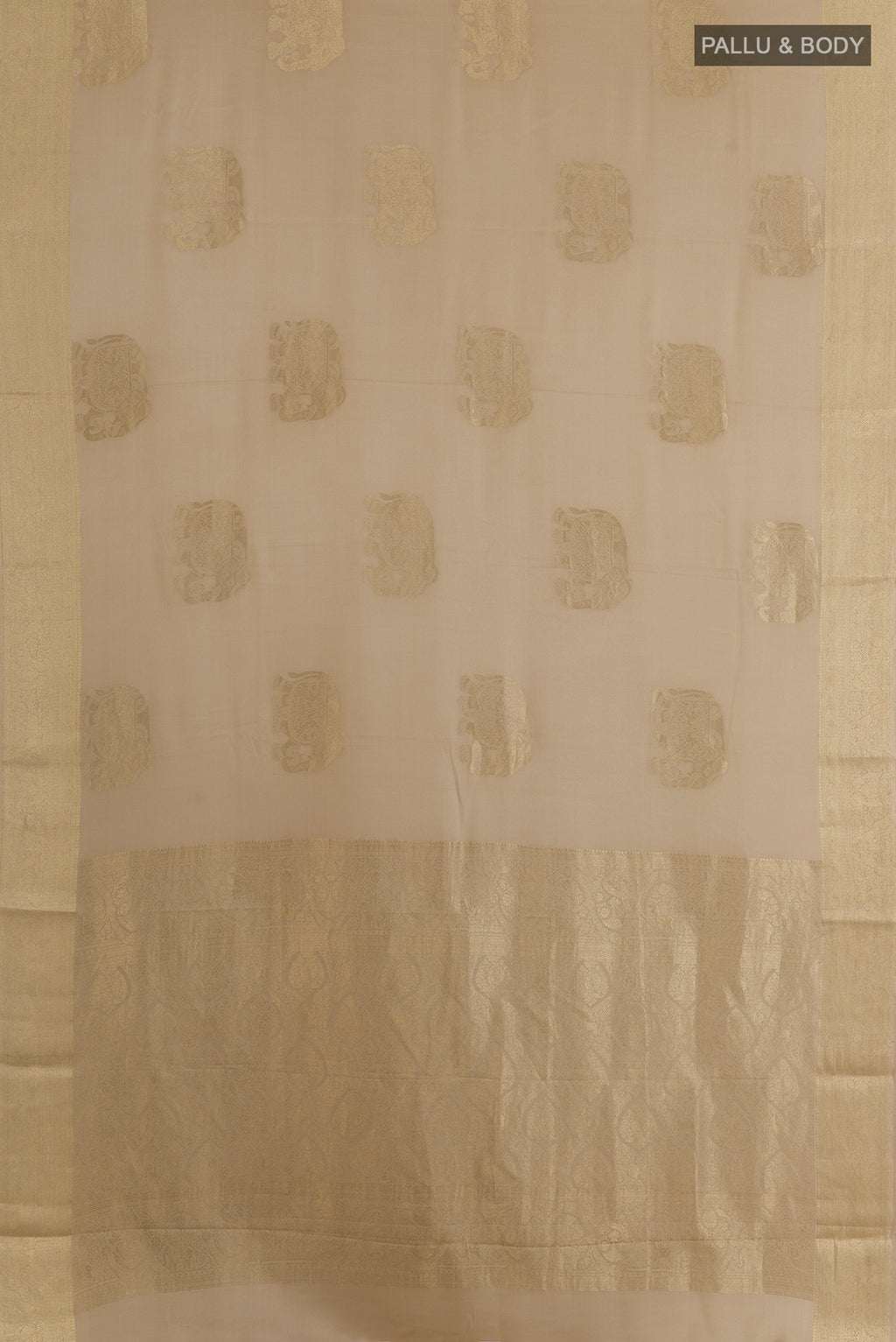 Flat view of Beige Mysore Crepe Saree with Zari Butta on the body and Zari Border. 