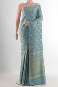 Light Blue Mysore Crepe Saree with Zari Butta on the body and Zari Border.  displayed on a mannequin