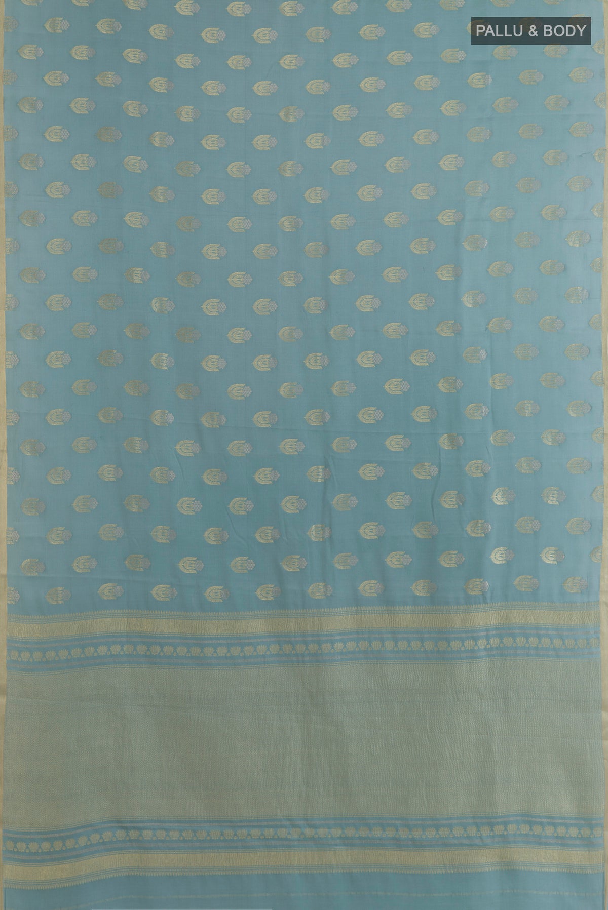 Flat view of Light Blue Mysore Crepe Saree with Zari Butta on the body and Zari Border. 