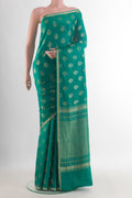 Sea Green Mysore Crepe Saree with Zari Butta on the body and Zari Border.  displayed on a mannequin