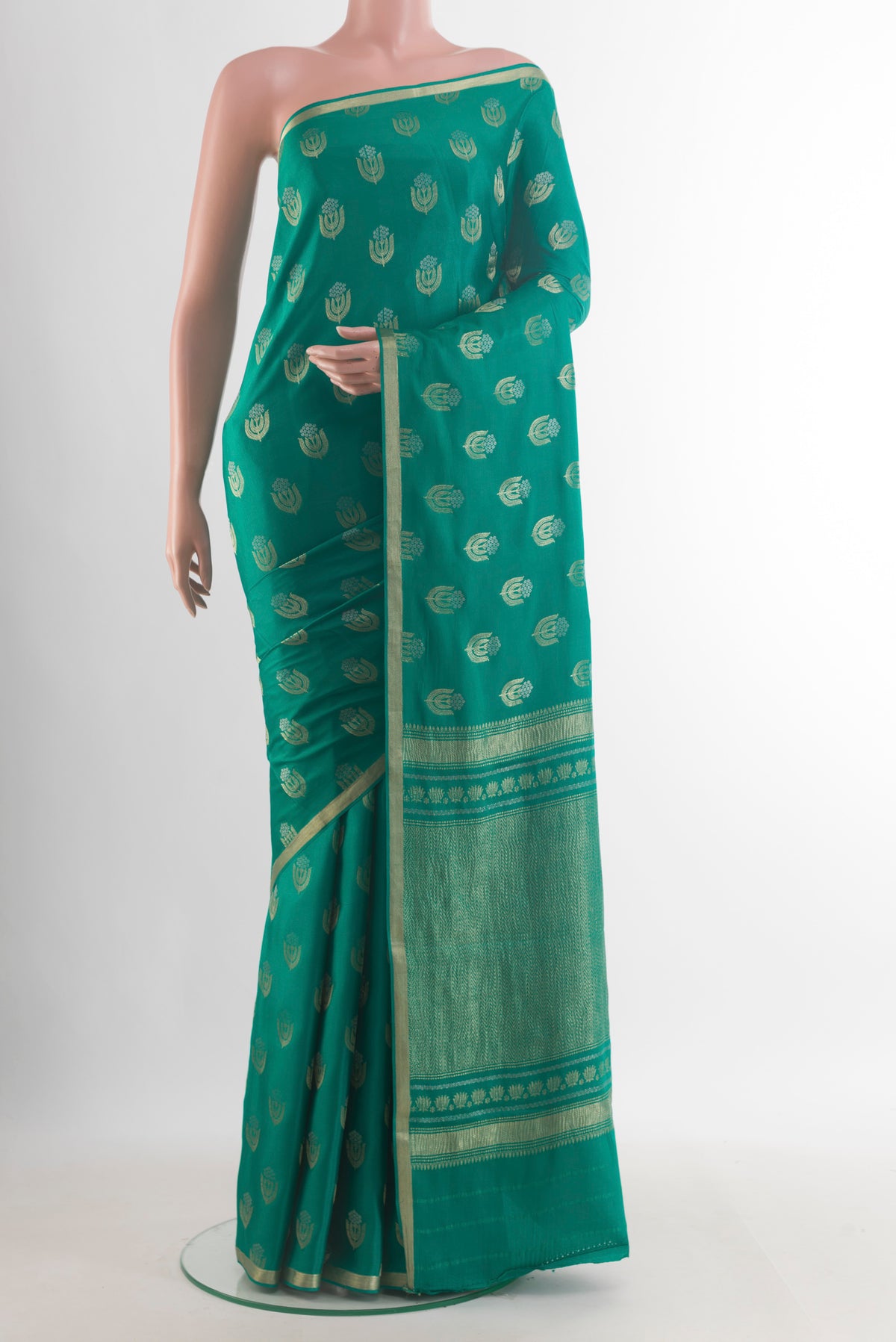 Sea Green Mysore Crepe Saree with Zari Butta on the body and Zari Border.  displayed on a mannequin