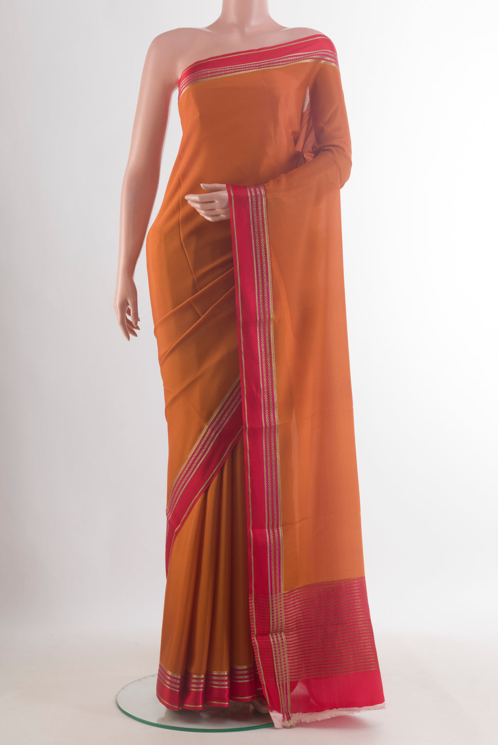 Brick Orange Mysore Crepe Saree with Plain Body and Zari Border.  displayed on a mannequin