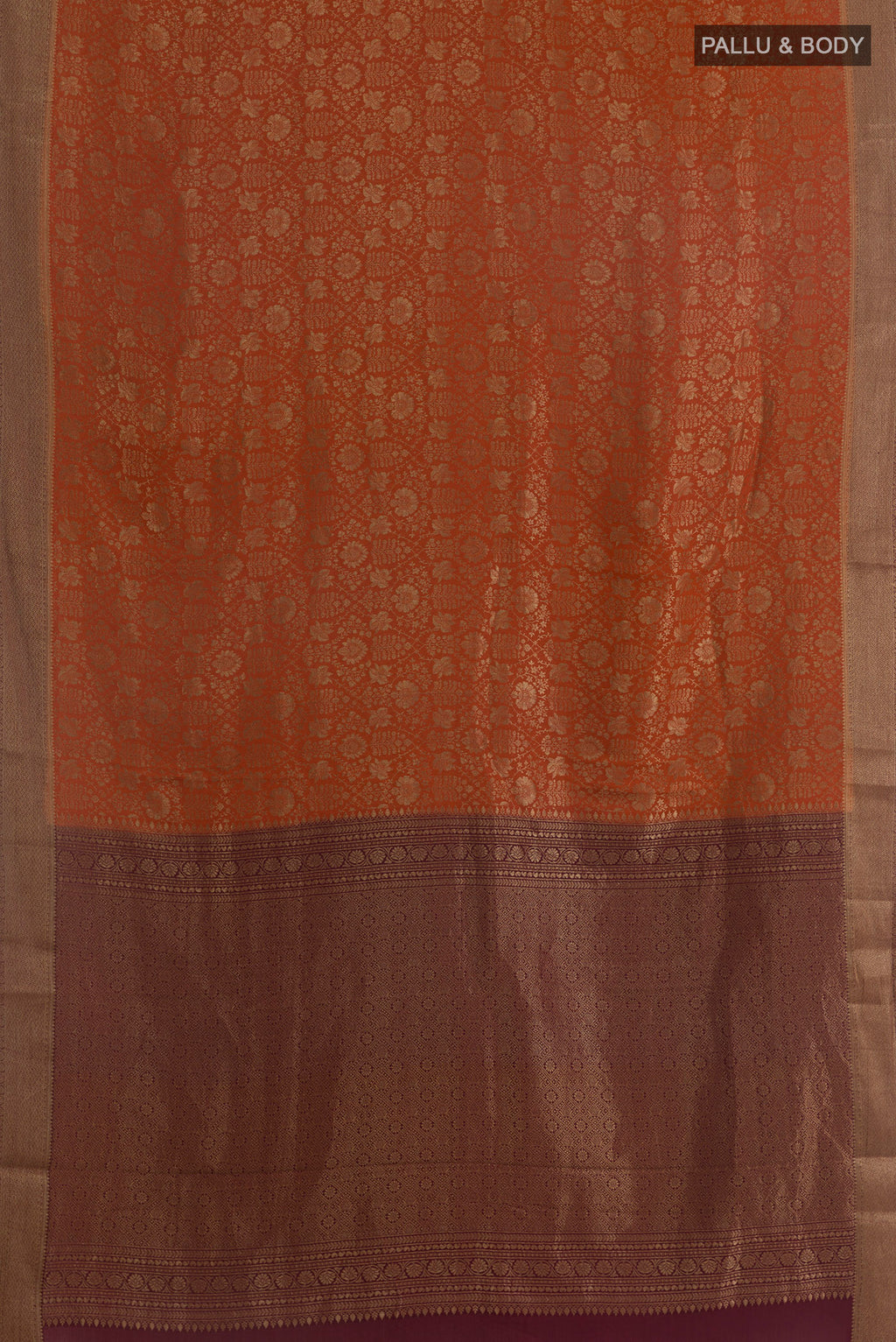 Flat view of Rust Mysore Crepe Saree with Zari Brocade on the body and Zari Border. 