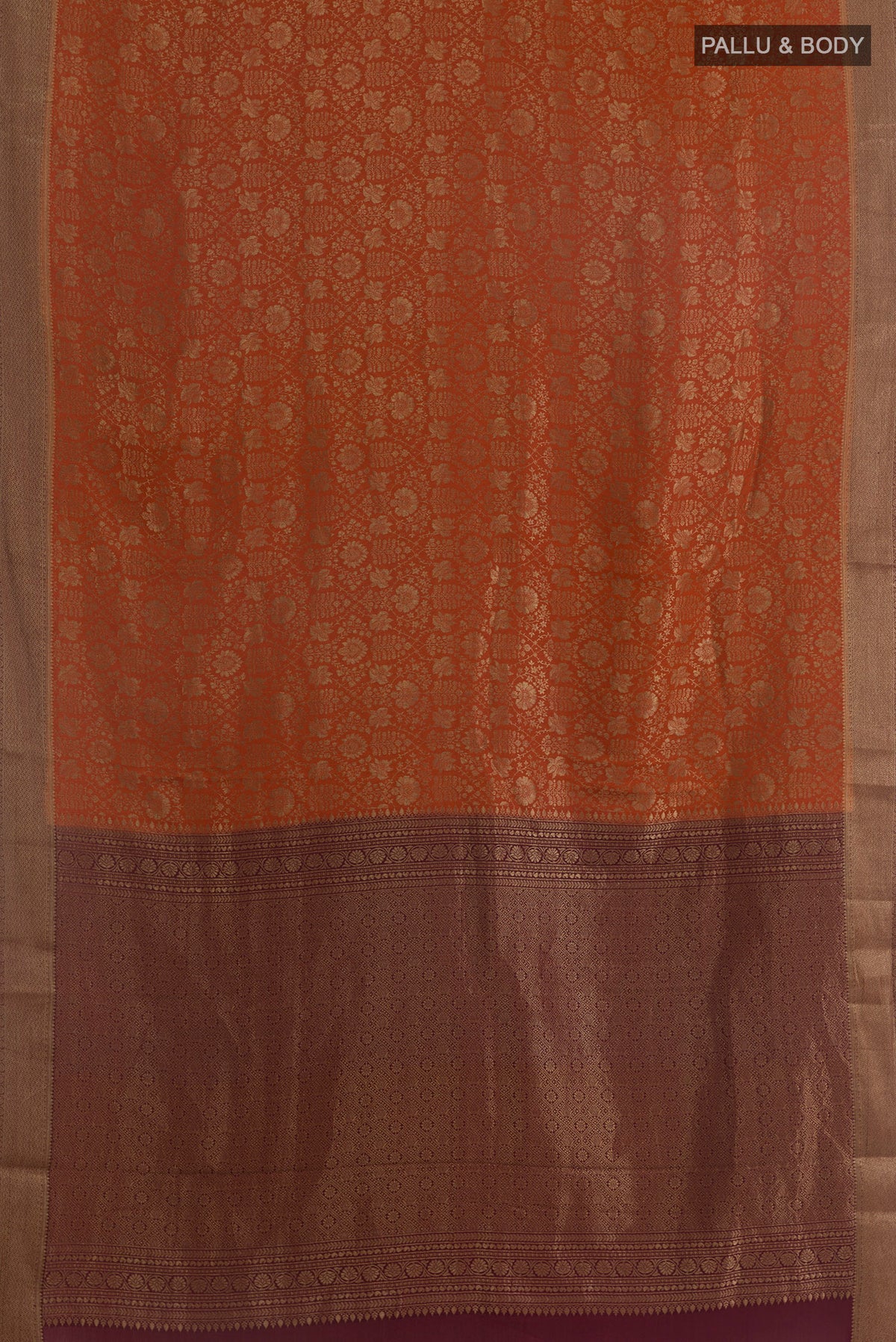 Flat view of Rust Mysore Crepe Saree with Zari Brocade on the body and Zari Border. 
