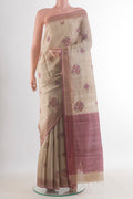 Beige Tussar Saree with Embroidered on the body and Zari Border.  displayed on a mannequin
