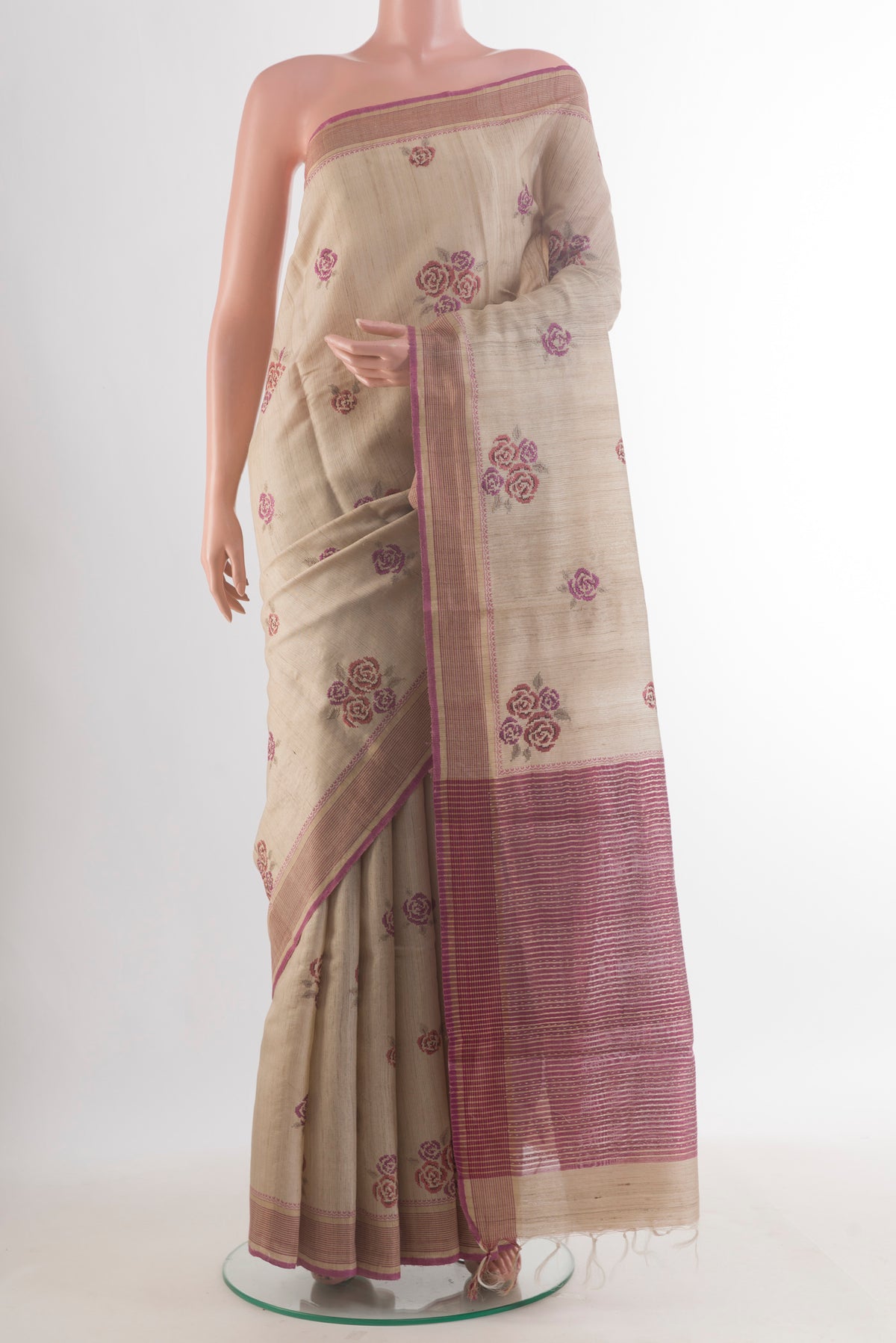 Beige Tussar Saree with Embroidered on the body and Zari Border.  displayed on a mannequin