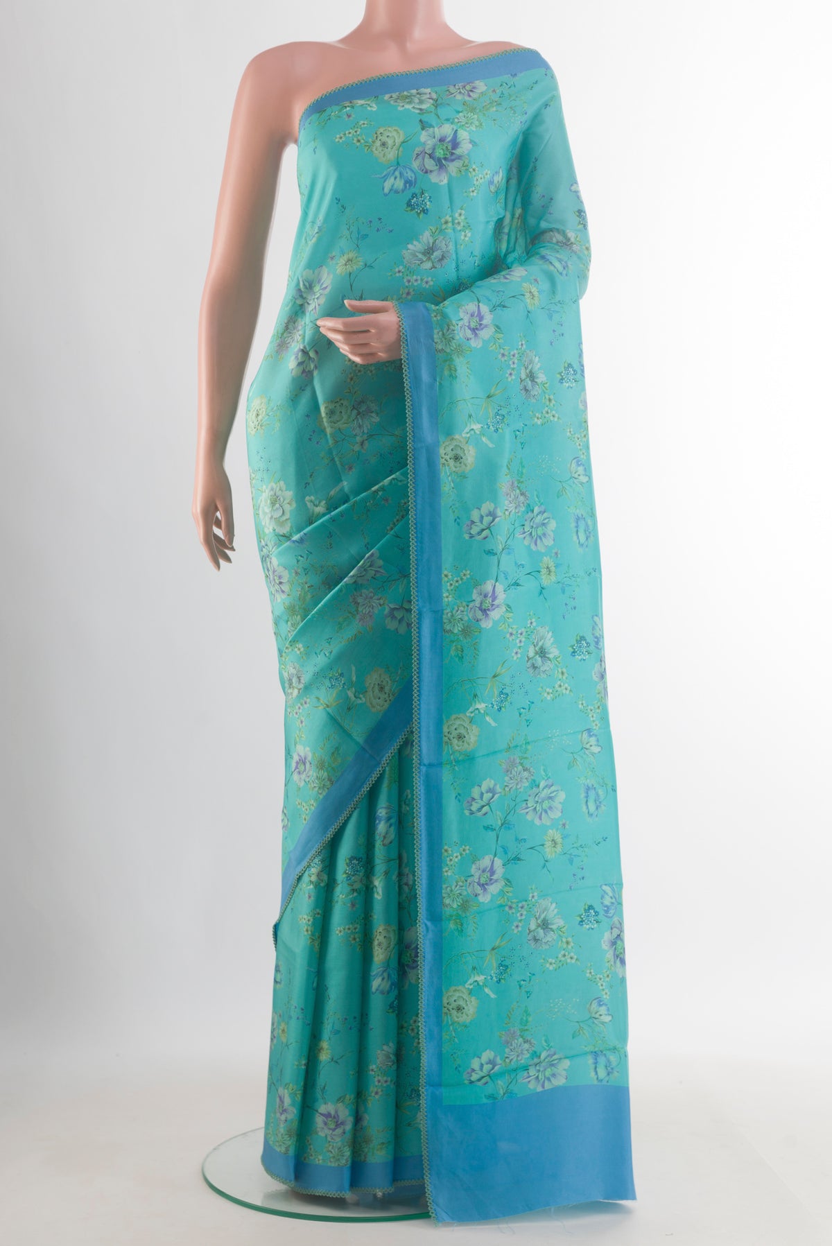 Pure Silk Light Blue Printed Saree with Printed design on the body and Printed Border.  displayed on a mannequin